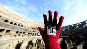 red glove with temple logo held up with colosseum in background
