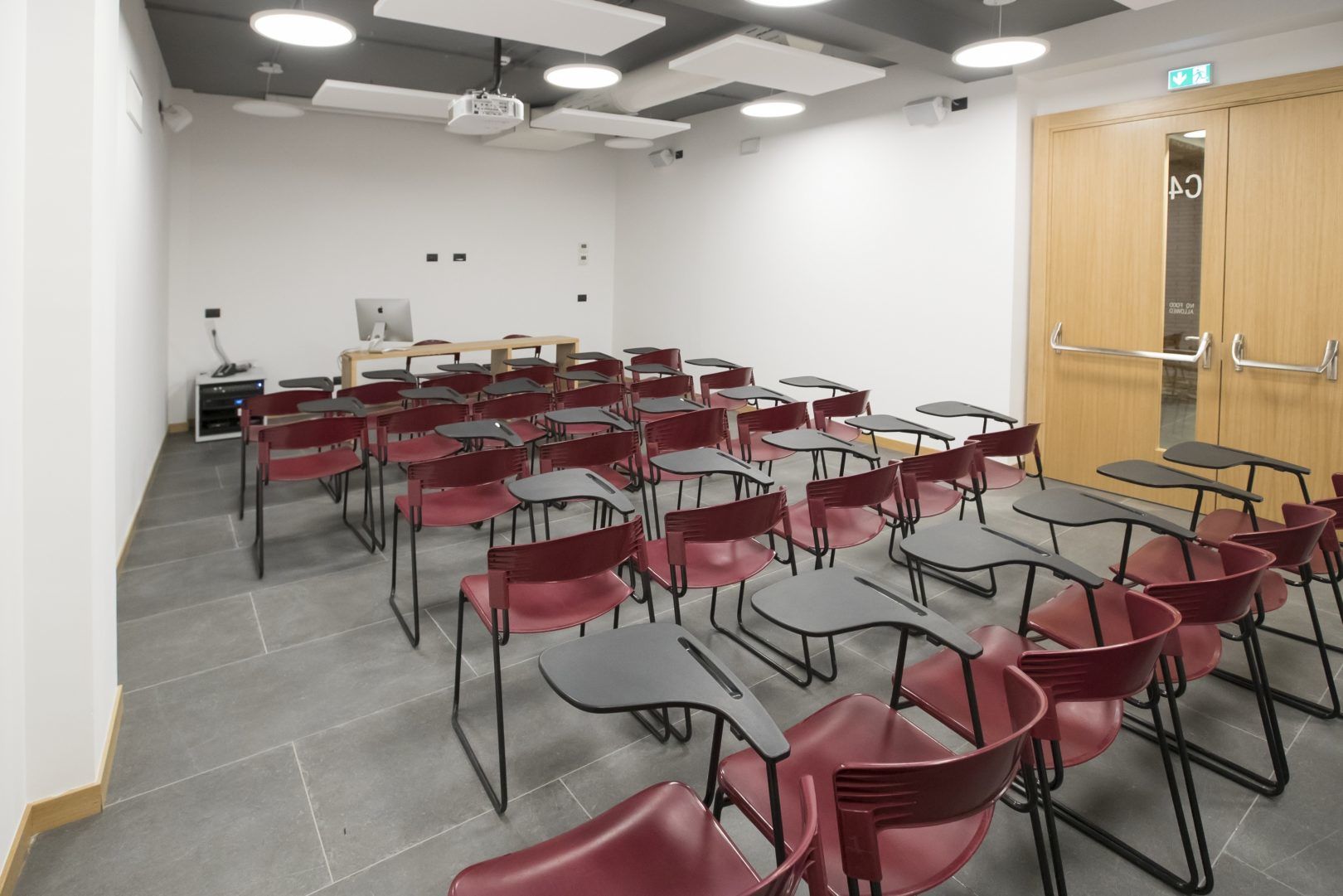 Classroom with rows of red chairs