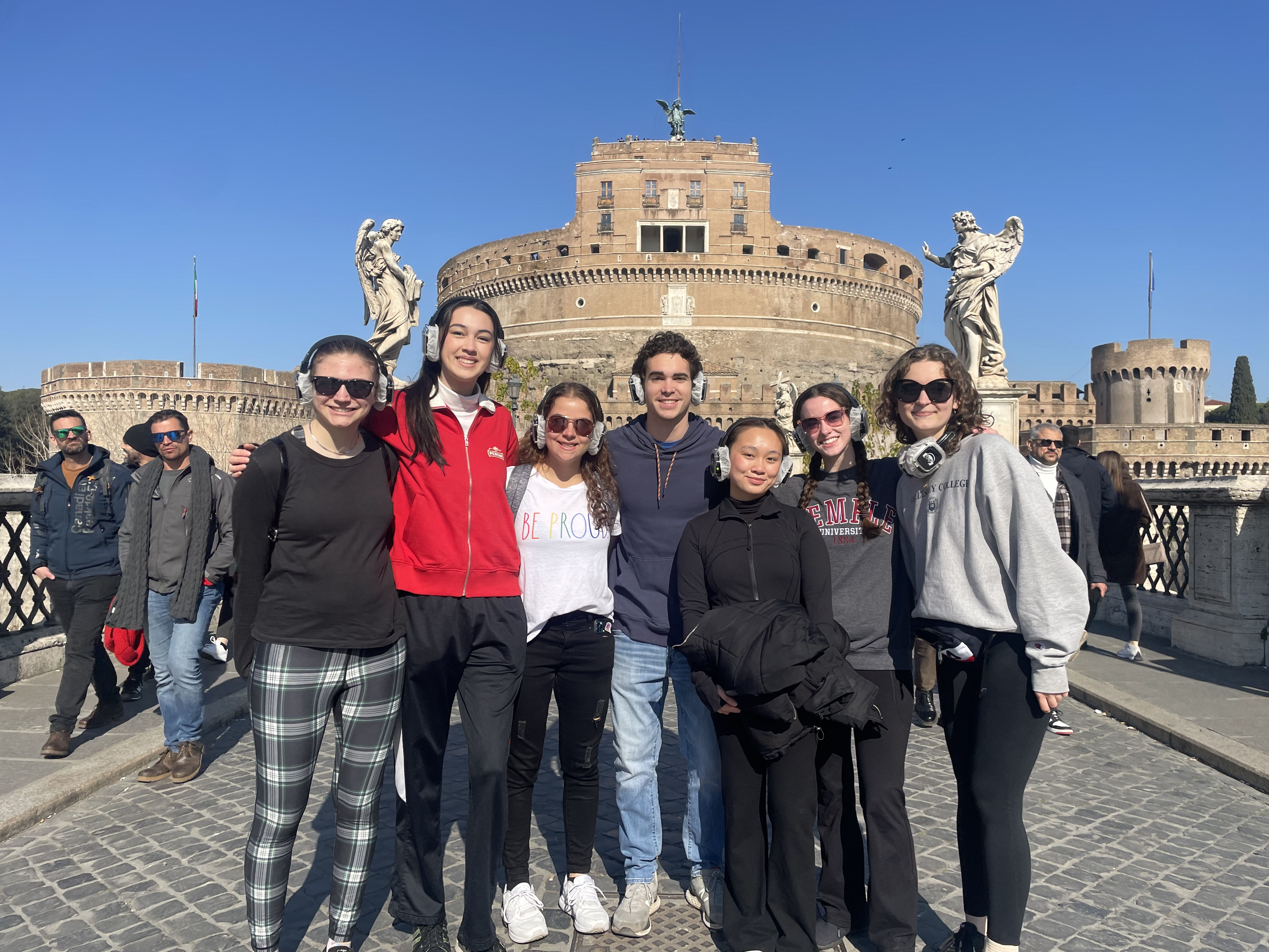 group of students smiling in front of castel sant'angelo in Rome