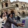 Students taking a selfie at the Colosseum