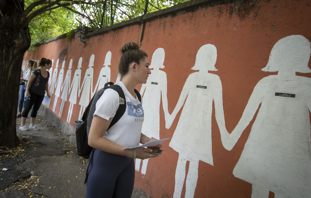 Female student looking at a mural in Rome