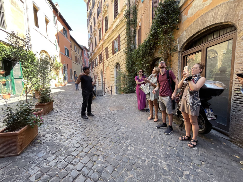 Professor speaking with group of adults in Rome