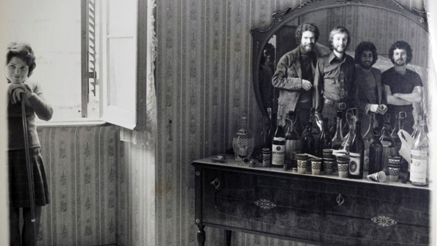 Four male college students posing in mirror reflection with woman on the left